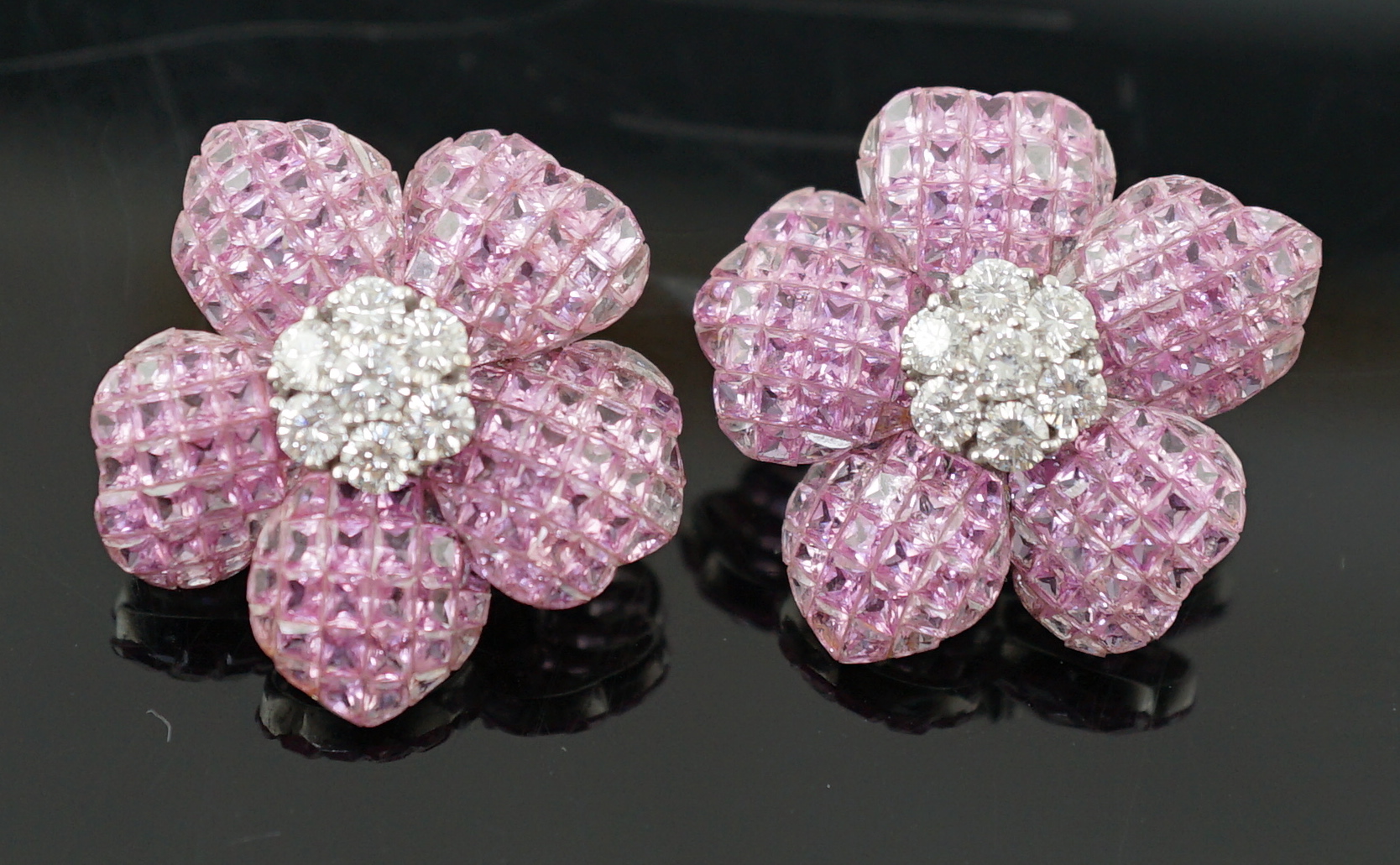 A pair of 18k white gold, pink sapphire and diamond cluster set flower head ear clips/earrings